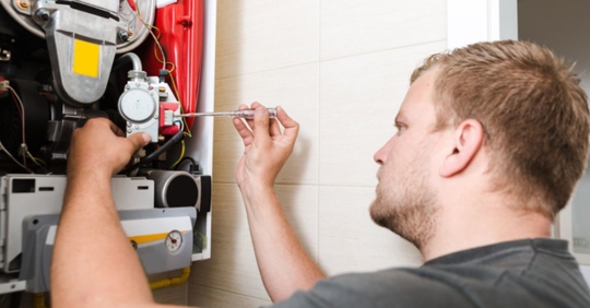 technician installing heating system